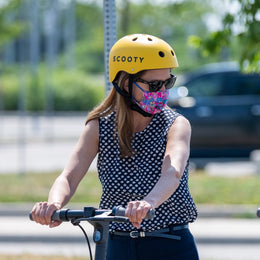Caroline Mulroney riding a Scooty with helmet and mask