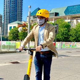 Omar Alghabra riding Scooty scooter with helmet